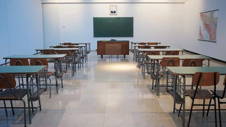 Empty school room with chalkboard and desks