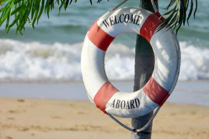 Ring buoy hanging on tree, saying "welcome aboard"